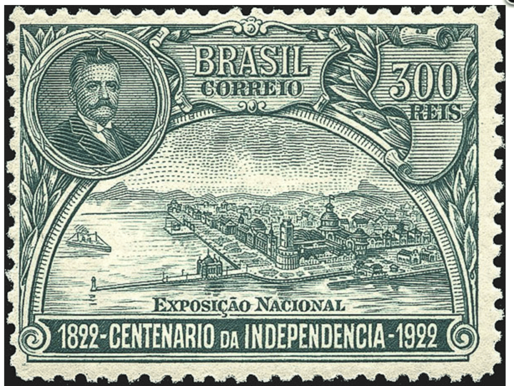 Green 300 réis Brazilian stamp from 1922 marking the centenary of independence, showing a presidential portrait and a view of the National Exposition in Rio de Janeiro, with a small lighthouse at the end of a breakwater